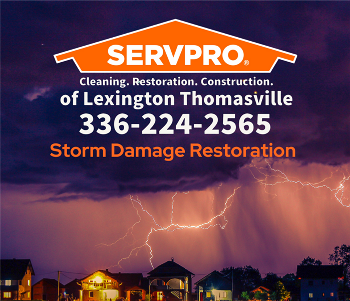 SERVPRO of Lexington/Thomasville business logo set in storm clouds over a city. 