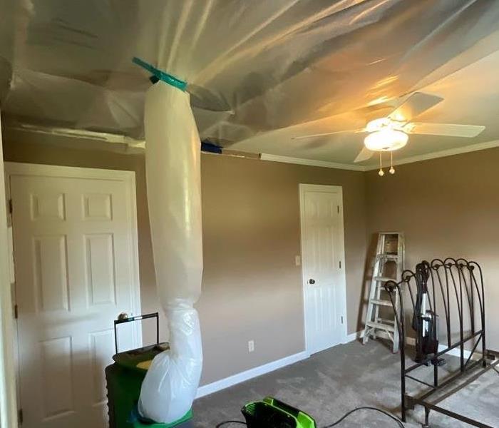 damaged ceiling due to water in an upstairs guest bedroom