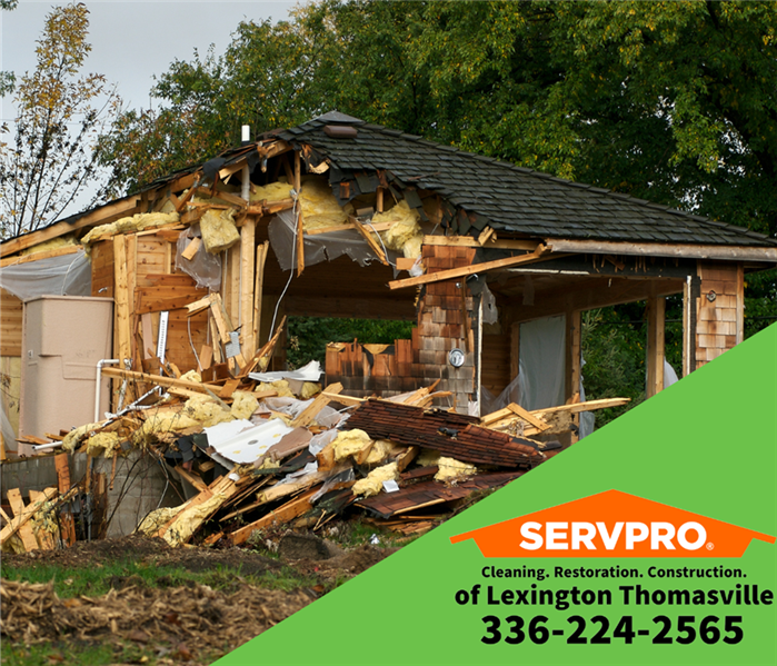 Home damaged by storm. SERVPRO of Lexington/Thomasville logo